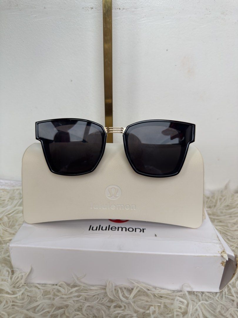 Lululemon Black Sunglasses with Case and Box (Category: Sunglasses & Eyewear) located in Consolacion. Submitted by naome1. (Listing ID 1468879873, Image 1). Description: - Brand: Lululemon - Model: 5805 (Size: 60-18-147) - Color: Classic black frame with elegant gold accents on the temples - Lenses: Dark tinted, square style - Origin: Made in Italy - Inclusions: Original cream-colored hard case and branded white storage box.