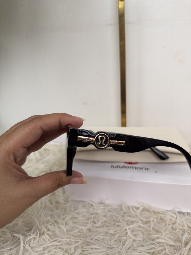 Lululemon Black Sunglasses with Case and Box (Category: Sunglasses & Eyewear) located in Consolacion. Submitted by naome1. (Listing ID 1468879873, Image 2). Description: - Brand: Lululemon - Model: 5805 (Size: 60-18-147) - Color: Classic black frame with elegant gold accents on the temples - Lenses: Dark tinted, square style - Origin: Made in Italy - Inclusions: Original cream-colored hard case and branded white storage box.