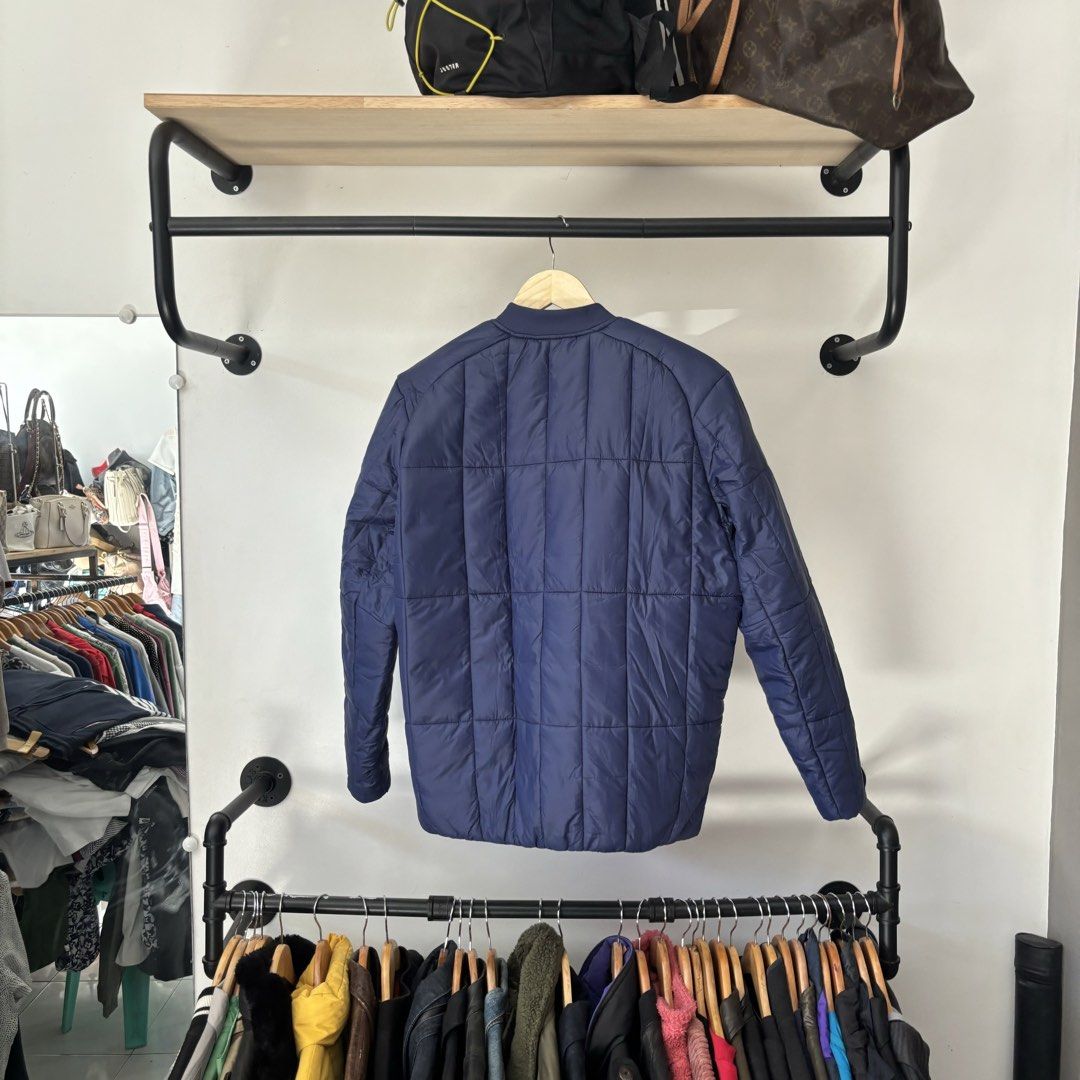 Lululemon Quilted Puffer Bomber Jacket Navy Blue (Category: Coats, Jackets and Outerwear) located in Bambang. Submitted by heats777 (Listing ID 1468817474, Image 3). Description: - Brand: Lululemon - Style: Quilted bomber jacket - Color: Deep navy blue - Closure: Zip-up front - Pockets: Secure zippered side pockets - Details: Ribbed collar and cuffs - Ideal for: Cooler weather and everyday athletic wear.