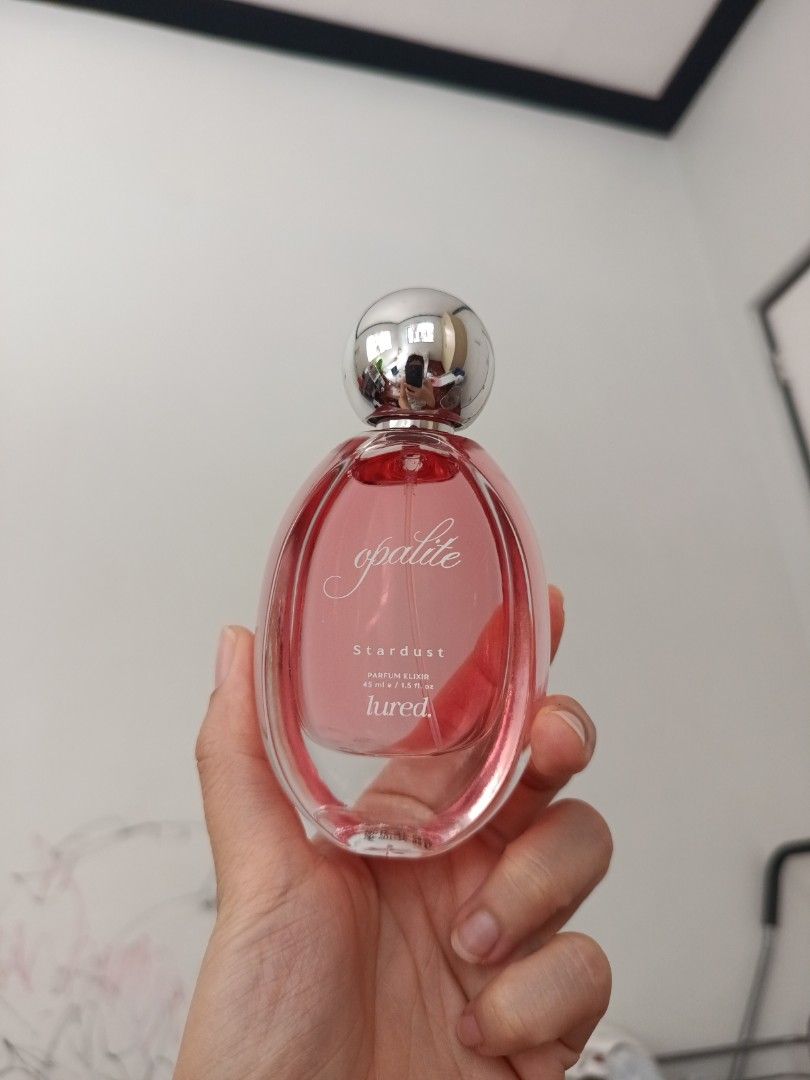Lured Opalite Stardust Parfum Elixir 45ml (Category: Fragrance & Deodorants) located in Quezon City. Submitted by cblakes (Listing ID 1468721480, Image 1). Description: - Brand/Model: Lured Stardust Parfum Elixir in Opalite - Volume: 45 ml / 1.5 fluid ounces - Packaging: Glass bottle with pink liquid and a sleek round silver cap - Design: Label printed directly on the front glass - Condition: Brand new and 100% authentic - Shipping: Fast shipping
