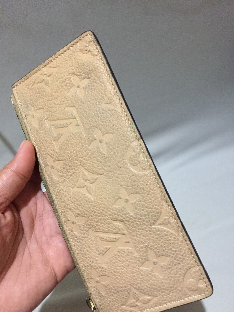 LV Empreinte Long Zip Wallet - Beige / Dune (Category: Luxury Bags & Wallets) located in Bulacan. Submitted by assorted.items (Listing ID 1468876759, Image 3). Description: LV Empreinte Long Zip Wallet - Beige / Dune 🤎 ✔️ Empreinte monogram embossed leather ✔️ Gold zip, LV engraved puller ✔️ Interior stamp: Louis Vuitton Paris made in France ✔️ Date code: SP1105 ✔️ Spacious - fits bills, cards, coins, phone Condition: Vintage preloved - may sign