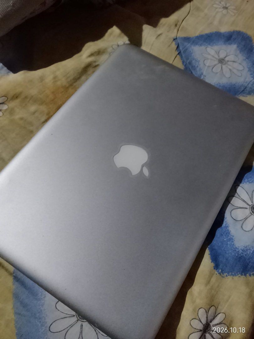 MacBook Pro 13-inch Early 2011 (Category: Laptops & Notebooks) located in Quezon City. Submitted by mjgaudier (Listing ID 1468875292, Image 2). Description: - Model: MacBook Pro 13-inch (Early 2011) - Color/Material: Silver aluminum body - Display: Glossy screen - Keyboard: Standard black keyboard with smooth trackpad - Design Features: Classic glowing Apple logo on the lid, complete with 4 rubber feet on the bottom case - Serial Number: C2WFD1EQ