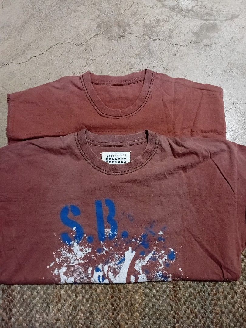 Maison Margiela Artisanal Reconstructed Tee (Category: Tshirts & Polo Shirts ) located in Makati City. Submitted by homme.boy.plus (Listing ID 1468832908, Image 3). Description: Maison Margiela SS13 Reddish brown with vintage wash reconstructed tee Large blue patterned square patch on the back, iconic four white stitches on upper back, and number tag with circled '10' inside collar Short sleeves, crew neck Excellent 21x28 .