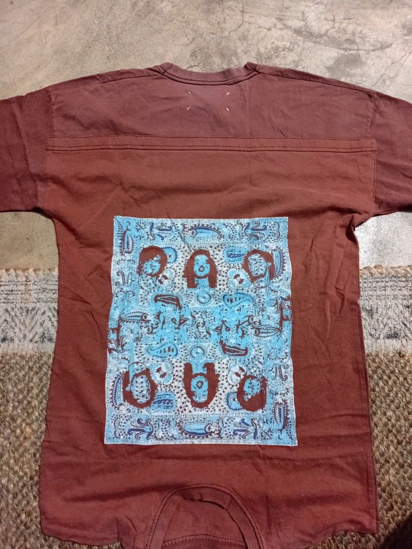 Maison Margiela Artisanal Reconstructed Tee (Category: Tshirts & Polo Shirts ) located in Makati City. Submitted by homme.boy.plus (Listing ID 1468832908, Image 1). Description: Maison Margiela SS13 Reddish brown with vintage wash reconstructed tee Large blue patterned square patch on the back, iconic four white stitches on upper back, and number tag with circled '10' inside collar Short sleeves, crew neck Excellent 21x28 .