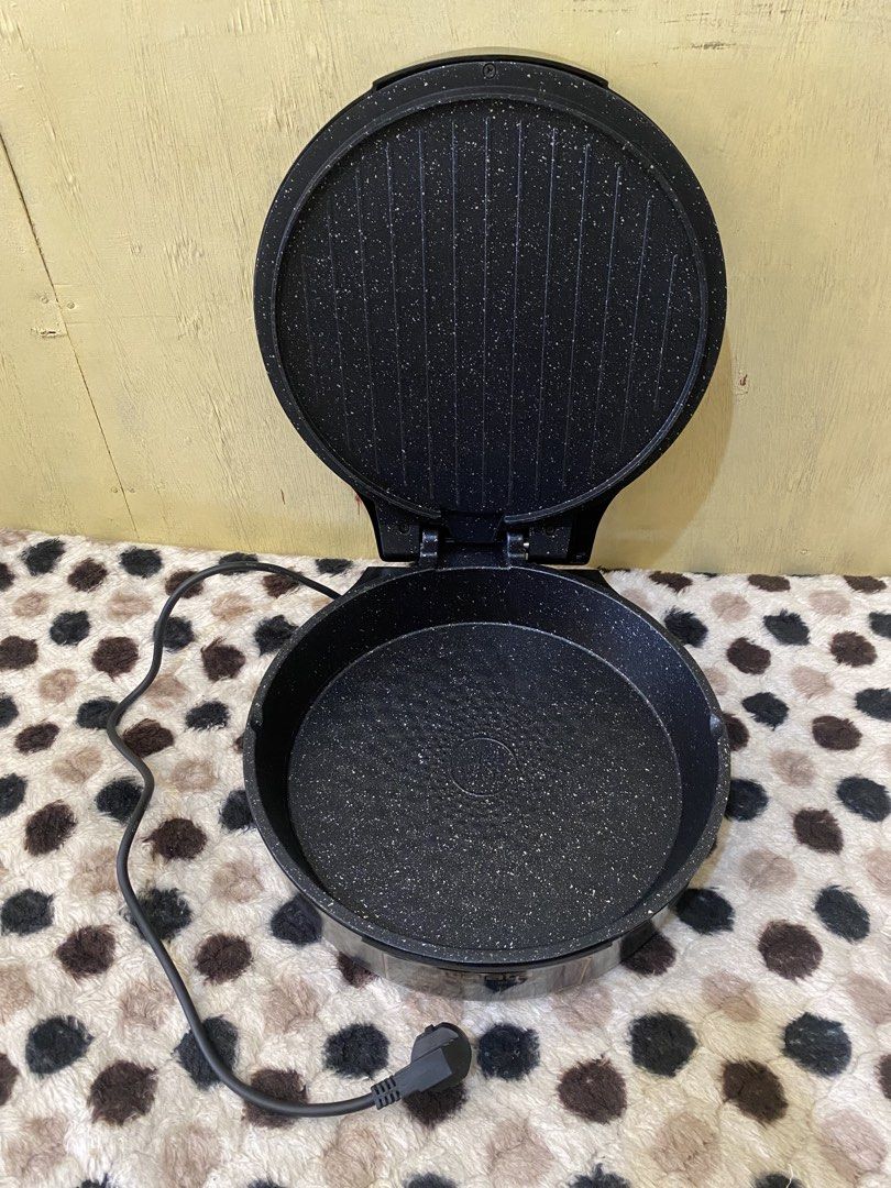 Malata Electric Baking Pan Non-Stick Griddle (Category: Cookware & Accessories) located in Baguio. Submitted by thrift_bonita (Listing ID 1468726081, Image 3). Description: - Brand: Malata - Color: Black with non-stick speckled cooking surface - Features: Dual power switches with indicator lights and built-in cooking time guide - Condition: Powers on and heats up normally, but has a noticeable crack on the top lid housing near the handle - Ideal 