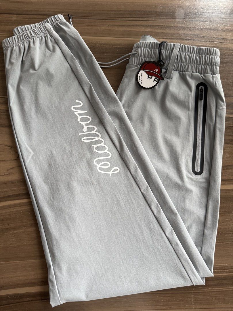 Malbon Golf Performance Nylon Tech Pants Grey Size S (Category: Trousers) located in Taguig. Submitted by laramagbalana (Listing ID 1468731058, Image 1). Description: - Brand: Malbon - Item: Performance Nylon Tech Pants - Color: Grey - Size: Small (S) - Condition: Brand new with original tags - Features: Elastic waistband with drawstring, zippered side pockets, printed Malbon script logo on right leg - SKU: M-8679 - Origin: Made in China.