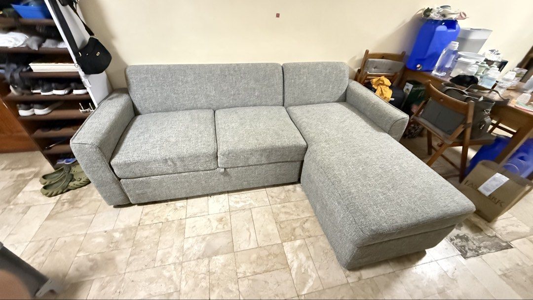 Mandaue Grey L-Shaped Sofa Bed with Storage (Category: Sofas) located in Paranaque City. Submitted by keyzer.soze (Listing ID 1468856322, Image 2). Description: - Colour/Material: Light grey textured fabric - Features: Built-in storage under chaise lounge & pull-out bed mechanism - Condition: Clean cushions and sturdy frame - Ideal for: Living rooms or guest rooms as a space-saving piece - Delivery: Self-collection needed Well maintained and with