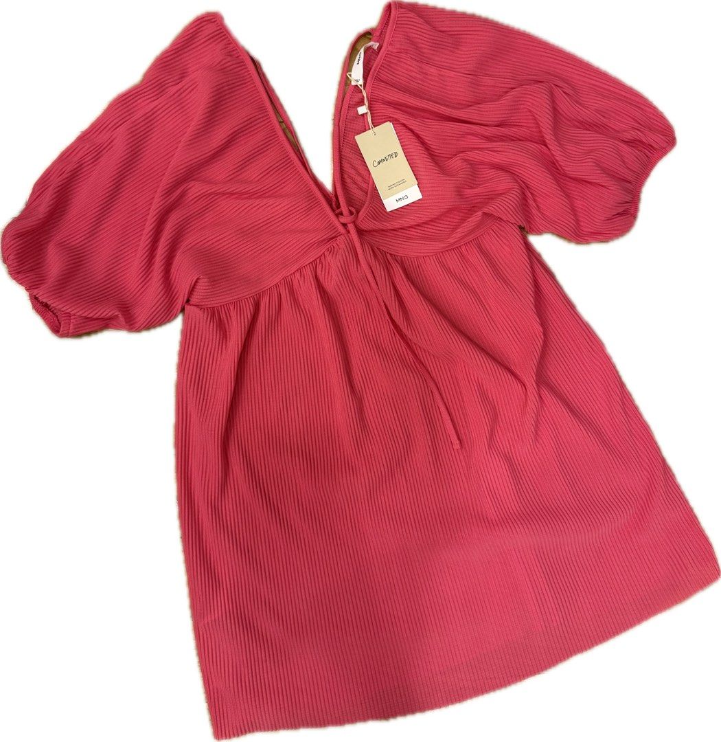 MANGO Pink Pleated Dress (Category: Dresses) located in Cavite. Submitted by fitarchive (Listing ID 1468717265, Image 1). Description: - Brand: Mango (Style: Vestido 440Valentin) - Condition: Brand new with original store tags attached, never worn - Color: Bright pink - Material: Textured ribbed fabric throughout - Design: Dramatic puff sleeves, deep V-neckline, and front center tie detail.