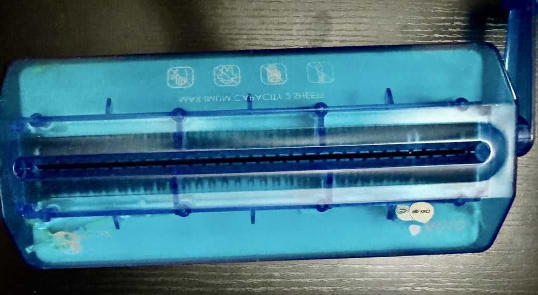Manual Hand Paper Shredder Blue (Category: Office & Business Technology) located in Manila. Submitted by clarovida888 (Listing ID 1468744448, Image 2). Description: - Type: Hand crank paper shredder with clear bin and blue lid - Capacity: Maximum of 2 sheets at a time - Cut Style: Strip-cut - Operation: Manual with a convenient side handle - Ideal Use: Home office desks, receipts, and small documents - Design: Compact size, easy to store anywhere