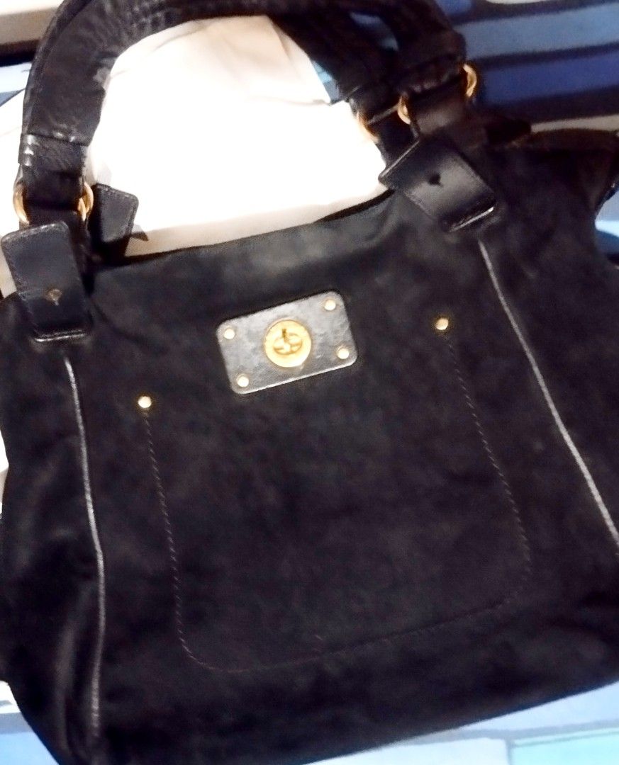 Marc by Marc Jacobs Black Suede Handbag (Category: Cross-body Bags) located in Manila. Submitted by lene48 (Listing ID 1468716569, Image 1). Description: - Brand: Marc by Marc Jacobs - Material: Black suede with gold-tone hardware - Closure: Turn-lock closure on front pocket - Straps: Double top handles and detachable leather shoulder strap - Interior: Roomy main compartment - Condition: Good pre-owned condition with minimal wear, orig mj.