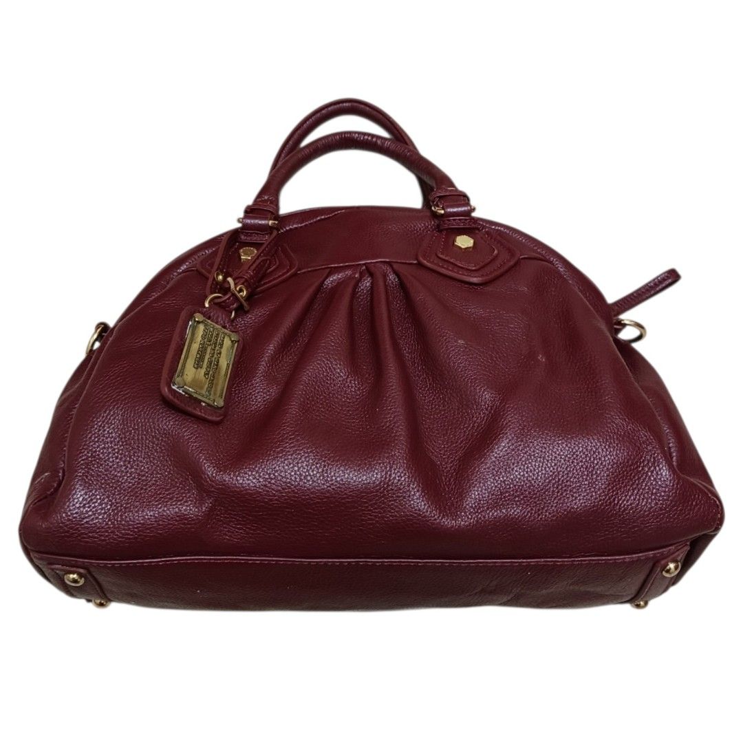 Marc by Marc Jacobs Leather Two Way Shoulder Bag (Category: Luxury Bags & Wallets) located in Nasugbu. Submitted by staffpicks1515 (Listing ID 1468788875, Image 2). Description: - Brand: Marc by Marc Jacobs - Material: Genuine burgundy leather with gold-tone hardware - Design: Gathered details with iconic Standard Supply metal plaque - Closure & Interior: Top zip closure, printed fabric lining, and inner zipper pocket - Handles: Dual top handles 