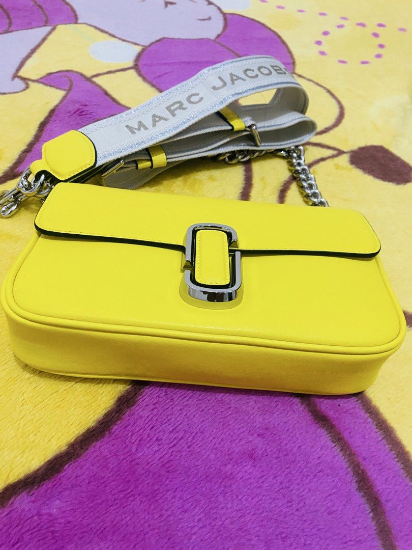 Marc Jacobs 2way Bag (Category: Luxury Bags & Wallets) located in San Jose del Monte. Submitted by cityhanter007 (Listing ID 1468822686, Image 2). Description: - Brand: Marc Jacobs - Color: Bright yellow with silver hardware - Design: Front chunky silver chain detail - Strap: Wide fabric strap with brand logo - Closure: Secure snap closure under flap - Condition: like new, clean interior and exterior with no scuffs - Perfect compact size to pop a