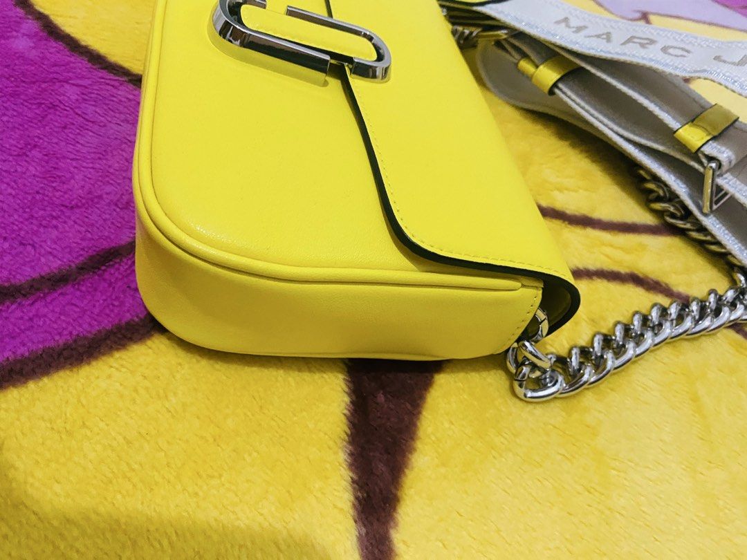 Marc Jacobs 2way Bag (Category: Luxury Bags & Wallets) located in San Jose del Monte. Submitted by cityhanter007 (Listing ID 1468822686, Image 3). Description: - Brand: Marc Jacobs - Color: Bright yellow with silver hardware - Design: Front chunky silver chain detail - Strap: Wide fabric strap with brand logo - Closure: Secure snap closure under flap - Condition: like new, clean interior and exterior with no scuffs - Perfect compact size to pop a