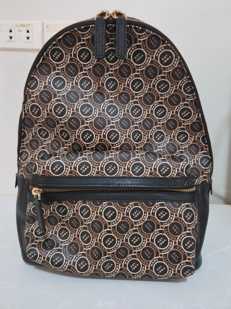 Marc Jacobs Backpack Signet Bagpack (Category: Luxury Bags & Wallets) located in Binan City. Submitted by thelleshop (Listing ID 1468776955, Image 2). Description: SUPER SALE! ✅️100% Authentic Original ✅️ With tag and care card ❌️ We don't sell fakes/replica Used few times In good condition Flaw: slight peeling of leather on bottom part only, kindly zoom in the pic. good thing bottom part so hindi halata :) gold metal hard ware still shiny Strict