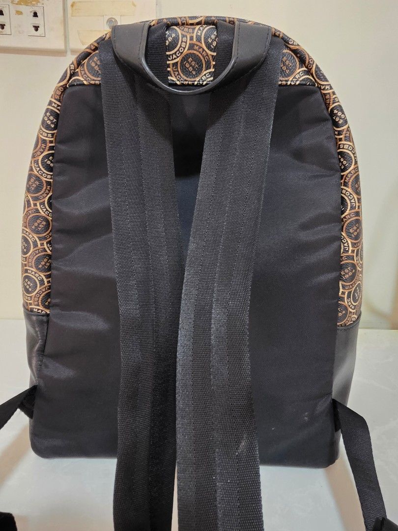 Marc Jacobs Backpack Signet Bagpack (Category: Luxury Bags & Wallets) located in Binan City. Submitted by thelleshop (Listing ID 1468776955, Image 3). Description: SUPER SALE! ✅️100% Authentic Original ✅️ With tag and care card ❌️ We don't sell fakes/replica Used few times In good condition Flaw: slight peeling of leather on bottom part only, kindly zoom in the pic. good thing bottom part so hindi halata :) gold metal hard ware still shiny Strict