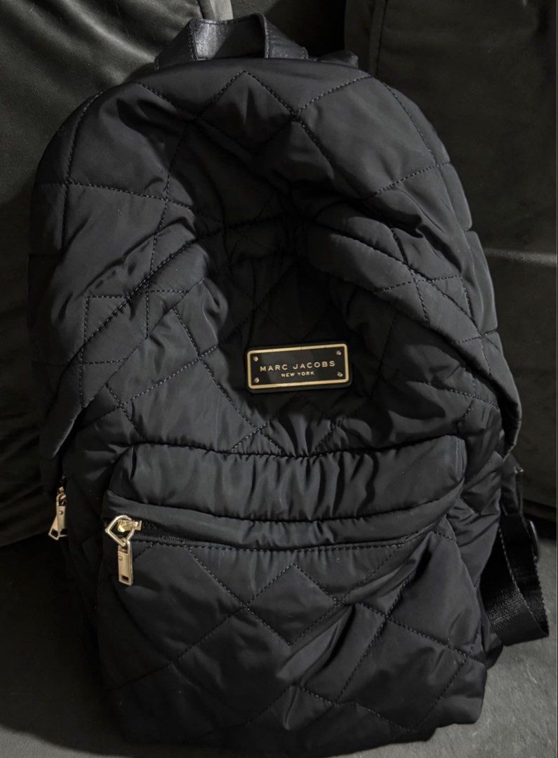 Marc Jacobs Black Quilted Nylon Backpack (Category: Backpacks) located in Mandaluyong City. Submitted by preloved.alyy (Listing ID 1468751330, Image 1). Description: Legit Reason for sale: I need a bigger backpack Minimal issue: - The zipper handle used to be a leather handle, but eventually nabakbak siya kaya pinalitan ko na ng metal. I can send photos ng previous zipper handle niya. - Top handle has minimal leather scratches. Still Negotiable.
