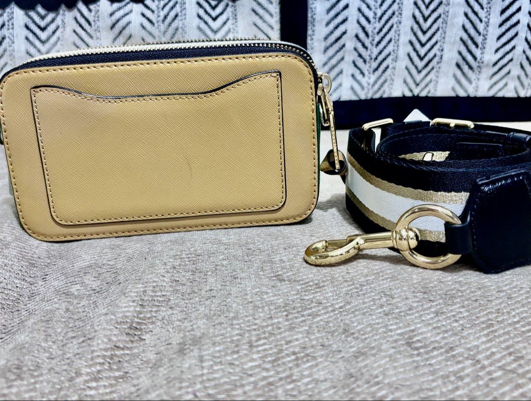 Marc Jacobs Snapshot Camera Bag Camel Gold (Category: Luxury Bags & Wallets) located in Mandaluyong City. Submitted by annaziki2001 (Listing ID 1468713162, Image 2). Description: - Brand: Marc Jacobs Snapshot Camera Bag - Color: Elegant camel leather with luxurious gold hardware - Compartments: Convenient double zip closure and a handy back slip pocket - Strap: Detachable and adjustable striped web strap in black, white, and gold - Size & Use: Co