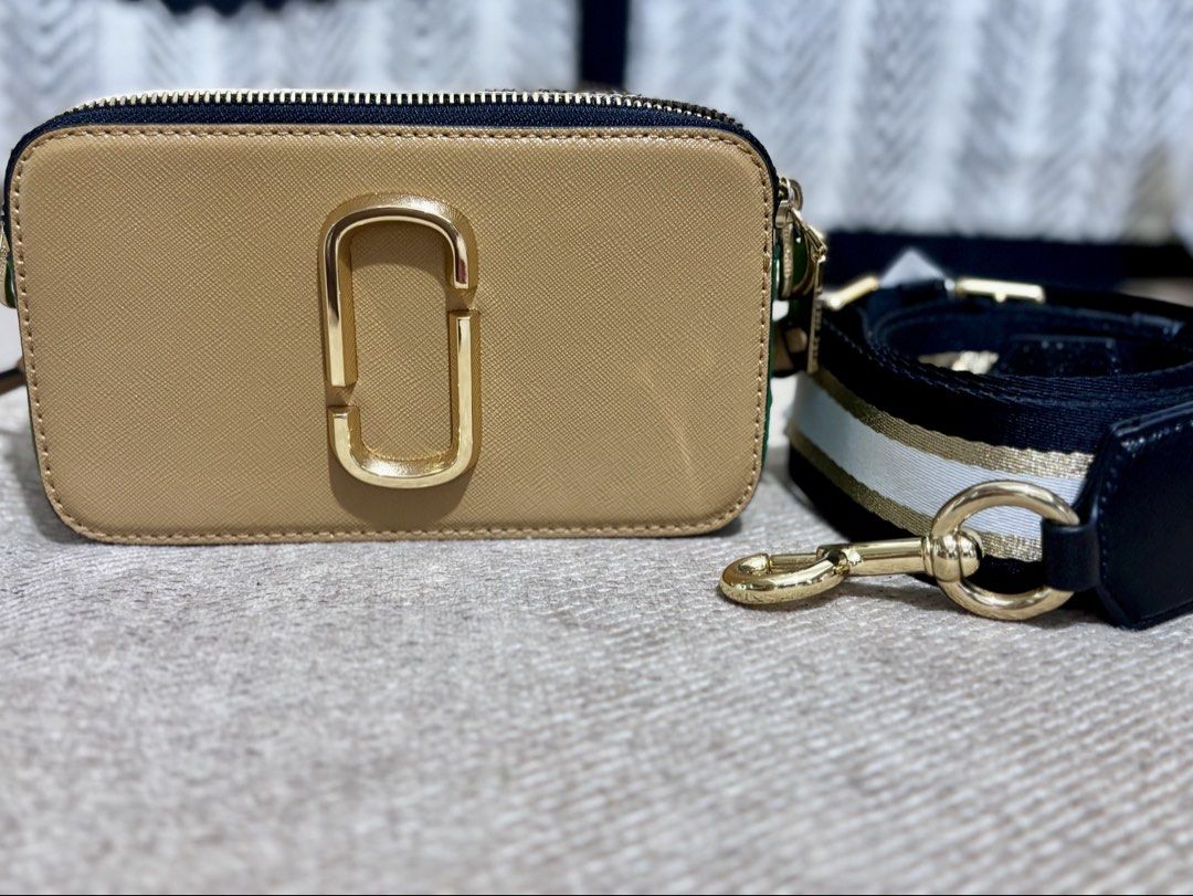 Marc Jacobs Snapshot Camera Bag Camel Gold (Category: Luxury Bags & Wallets) located in Mandaluyong City. Submitted by annaziki2001 (Listing ID 1468713162, Image 1). Description: - Brand: Marc Jacobs Snapshot Camera Bag - Color: Elegant camel leather with luxurious gold hardware - Compartments: Convenient double zip closure and a handy back slip pocket - Strap: Detachable and adjustable striped web strap in black, white, and gold - Size & Use: Co