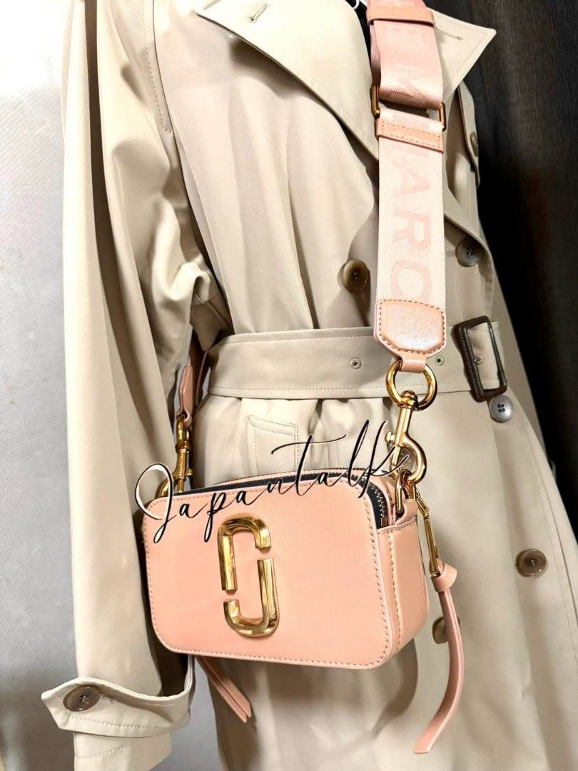 Marc Jacobs Snapshot Camera Bag Pink (Category: Luxury Bags & Wallets) located in Bulacan. Submitted by vintage_purge (Listing ID 1468797541, Image 3). Description: - Brand: Marc Jacobs Snapshot Bag - Color: Dusty Pink with Gold-tone hardware - Material: Durable Saffiano leather - Design: Iconic double-J logo, dual zip compartments, and back slip pocket - Straps included: 1x branded wide fabric strap AND 2x bonus interchangeable chains (gold and 