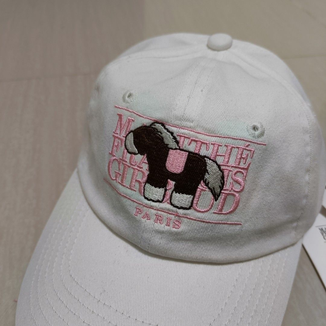 Marithe Francois Girbaud Pony Classic Logo Covered Cap (Category: Caps & Hats) located in Nasugbu. Submitted by staffpicks1515 (Listing ID 1468794130, Image 3). Description: - Brand: Marithe Francois Girbaud - Style: Pony Classic Logo Covered Cap - Color: Ivory with cute pony embroidery and pink lettering - Material: 100% cotton - Size: Standard 58cm circumference with adjustable strap back - Condition: Brand new, never used, with original hangta