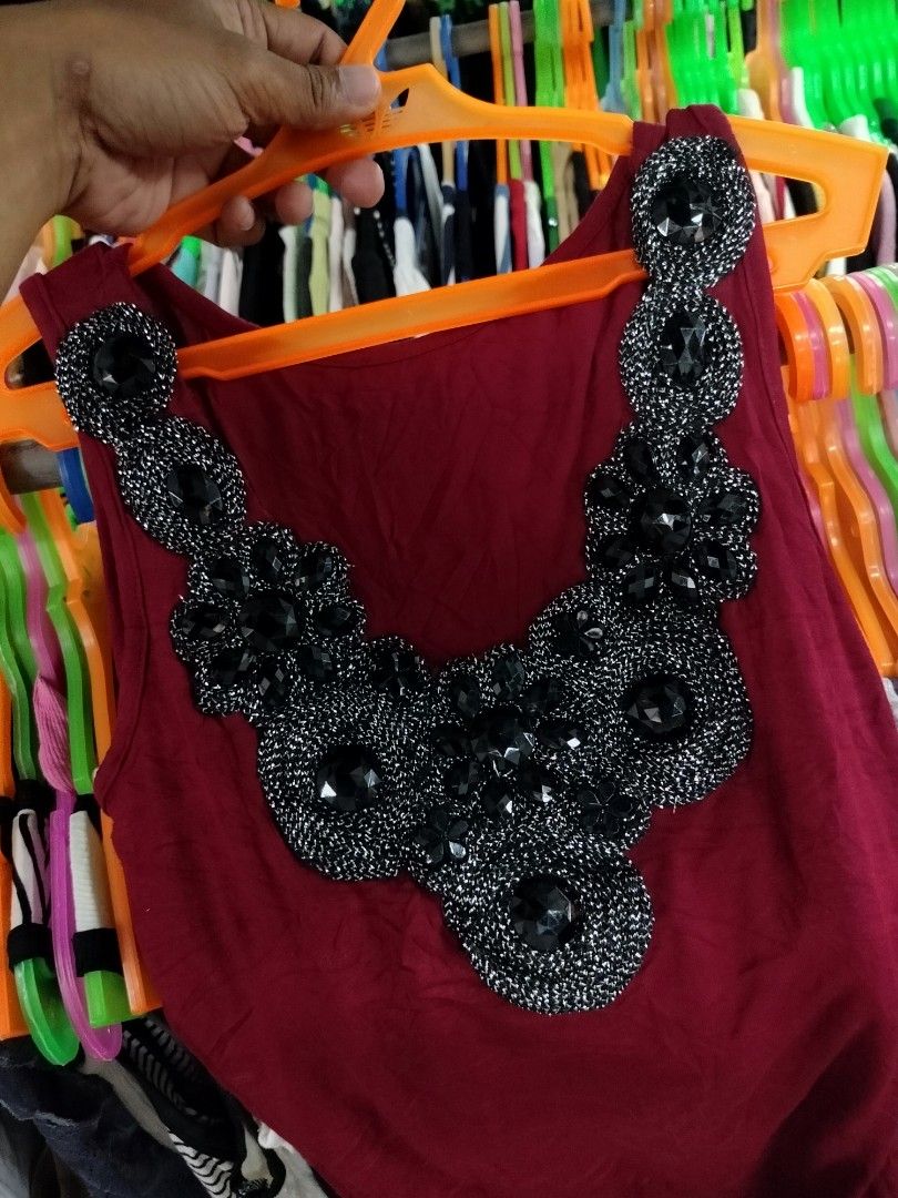 Maroon Tank Top with Rhinestone Collar (Category: Sleeveless) located in Manila. Submitted by virgiliosa38485 (Listing ID 1468718953, Image 2). Description: - Color: Maroon - Style: Sleeveless top with scoop neckline and standard fit - Detail: Bold black rhinestone and silver beaded collar - Material: Soft, stretchable, and very comfortable - Versatility: Perfect for casual wear with jeans/shorts or dressed up for the evening.
