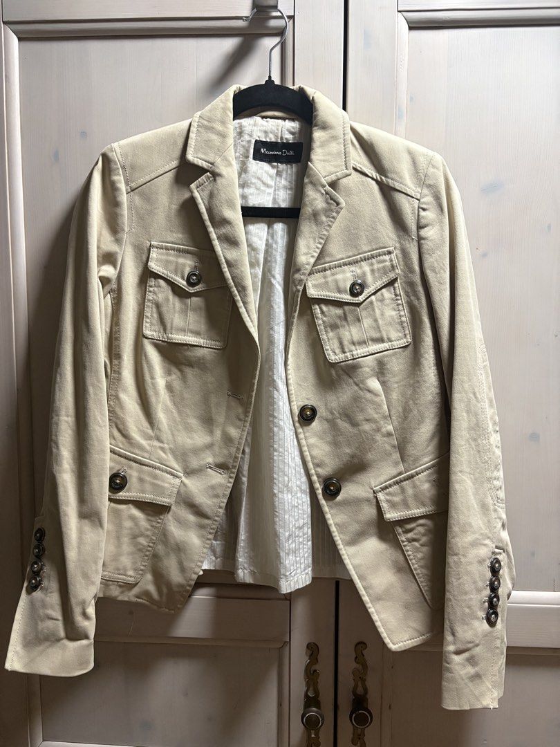 Massimo Dutti Beige Cotton Blend Blazer Jacket (Category: Coats, Jackets and Outerwear) located in Quezon City. Submitted by iris.edit (Listing ID 1468900310, Image 1). Description: - Brand: Massimo Dutti - Style: Classic structured fit beige blazer jacket - Size: 38 - Material: 97% cotton, 3% spandex outer shell; cotton and polyester blend lining - Details: Front button closures, buttoned cuffs, and utility chest pockets - Origin: Made in Portug