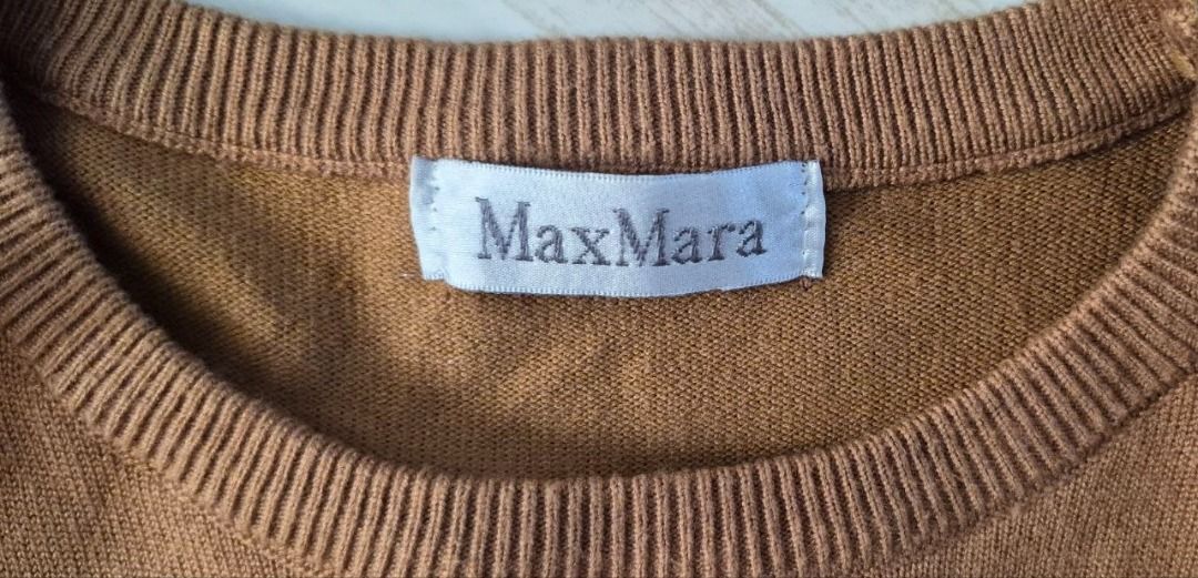 Max Mara Brown Knit Sweater with Graphic Print (Category: Longsleeves) located in Taguig. Submitted by regimennn (Listing ID 1468831149, Image 2). Description: - Brand: Max Mara Fits Small - Medium - Color: Brown - Material: Warm wool blend with a soft texture - Design: Long sleeves, crew neckline, ribbed cuffs and hem - Graphic: Large front box design featuring 'MA QUESTO E' UN CAPOLAVORO!' and year 1951.