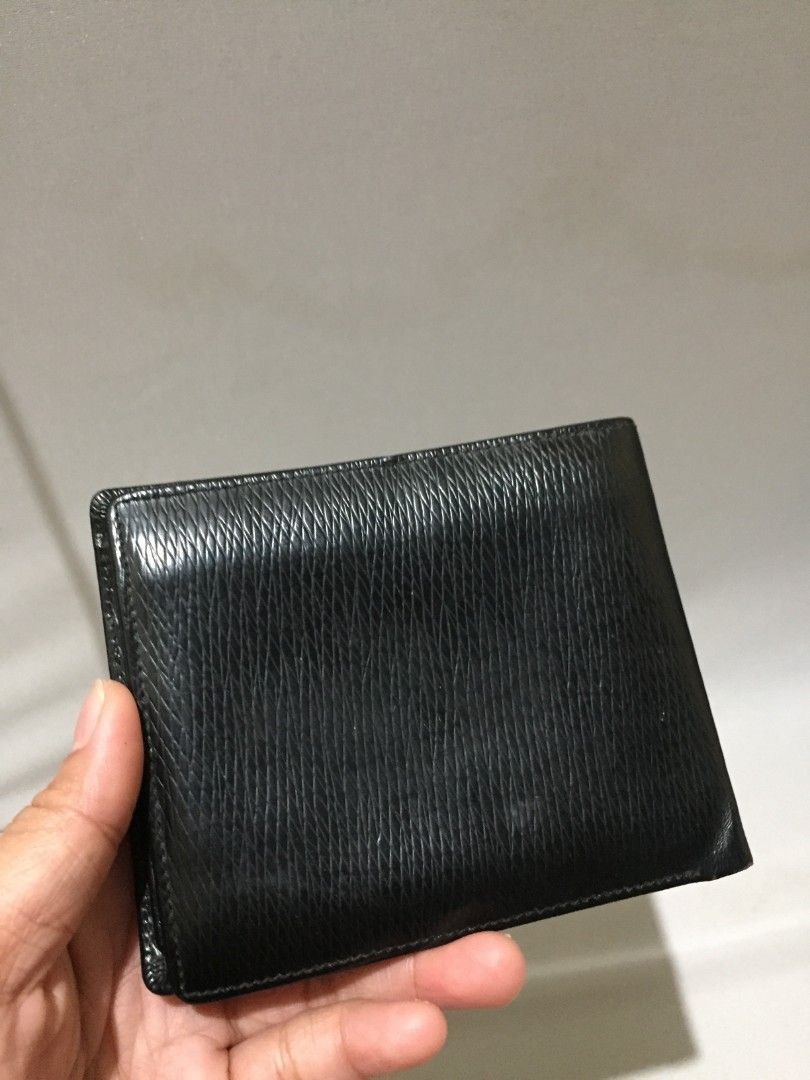 MCM BLACK BIFOLD WALLET (Category: Wallets & Card Holders) located in Bulacan. Submitted by assorted.items (Listing ID 1468872770, Image 2). Description: MCM BLACK BIFOLD WALLET 🖤 ✔️ Original MCM - black saffiano / crosshatched leather ✔️ Silver MCM plate hardware (front) ✔️ Embossed MCM logo inside ✔️ ID window + multiple card slots + 2 bill compartments ✔️ Genuine leather Condition: Used but well kept - no major bakbak, leather still makintab,