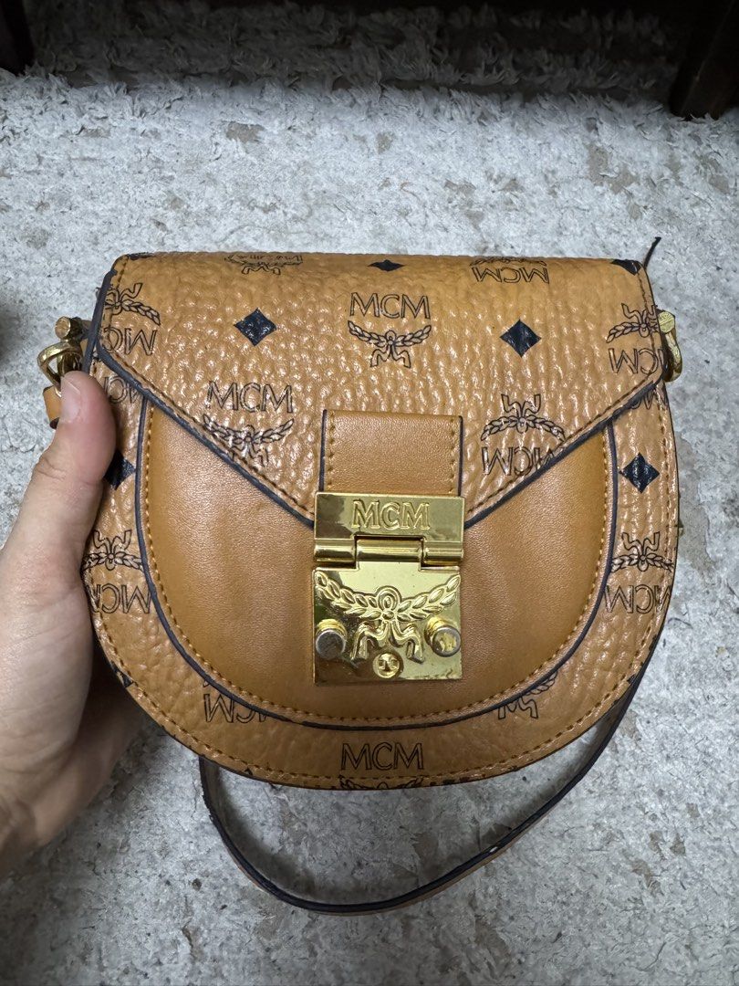 Mcm cognac sling bag (Category: Luxury Bags & Wallets) located in Makati City. Submitted by meticoolous (Listing ID 1468858025, Image 2). Description: what you see is what you get second hand item, bawal sa maselan flaws: rubber lining not that intact discoloration in hardware loc: Rodriguez Rizal.