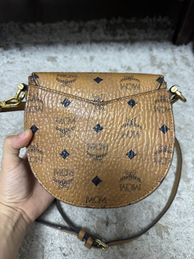 Mcm cognac sling bag (Category: Luxury Bags & Wallets) located in Makati City. Submitted by meticoolous (Listing ID 1468858025, Image 3). Description: what you see is what you get second hand item, bawal sa maselan flaws: rubber lining not that intact discoloration in hardware loc: Rodriguez Rizal.