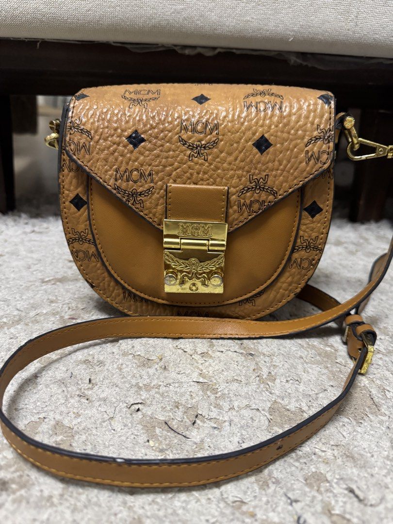 Mcm cognac sling bag (Category: Luxury Bags & Wallets) located in Makati City. Submitted by meticoolous (Listing ID 1468858025, Image 1). Description: what you see is what you get second hand item, bawal sa maselan flaws: rubber lining not that intact discoloration in hardware loc: Rodriguez Rizal.