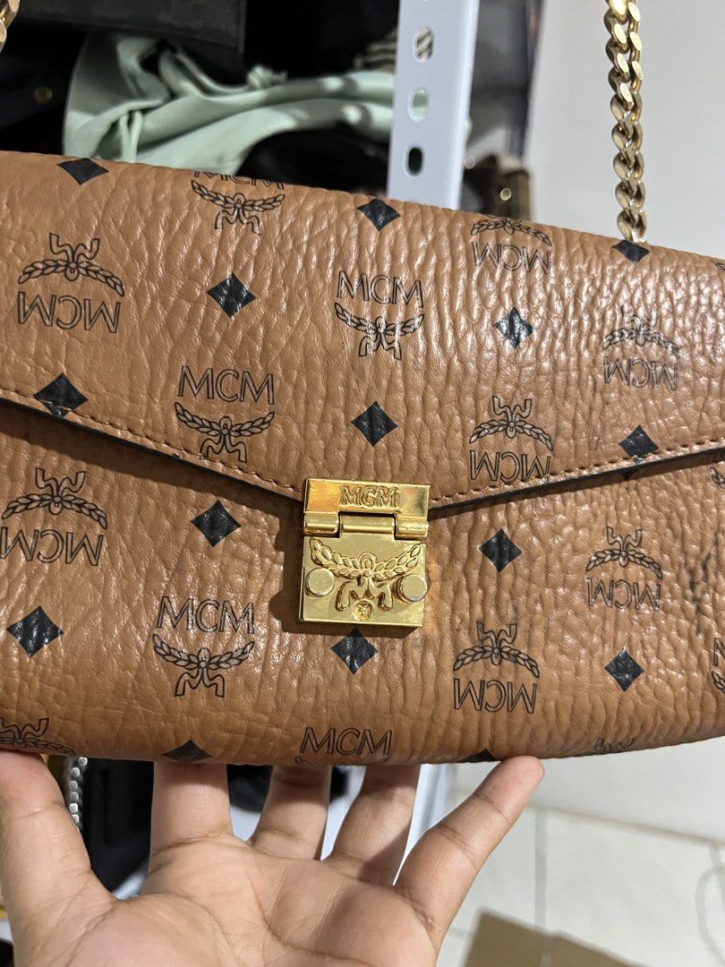 MCM Cognac Visetos Monogram Crossbody Bag (Category: Luxury Bags & Wallets) located in Muntinlupa City. Submitted by armendaber03743 (Listing ID 1468767528, Image 2). Description: - Brand: MCM - Material: Brown leather with iconic monogram print - Hardware: Premium gold-toned - Strap: Chic chain shoulder strap - Closure: Secure front turn-lock - Interior: Fabric lining with a zipped pocket and brand tag - Design: Structured accordion side gussets