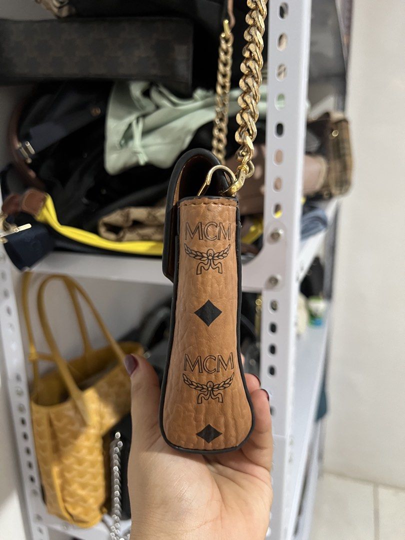 MCM Cognac Visetos Monogram Crossbody Bag (Category: Luxury Bags & Wallets) located in Muntinlupa City. Submitted by armendaber03743 (Listing ID 1468767528, Image 3). Description: - Brand: MCM - Material: Brown leather with iconic monogram print - Hardware: Premium gold-toned - Strap: Chic chain shoulder strap - Closure: Secure front turn-lock - Interior: Fabric lining with a zipped pocket and brand tag - Design: Structured accordion side gussets