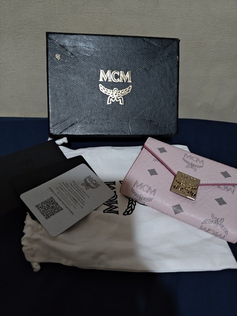 MCM Pink Monogram Envelope Trifold Wallet with Box (Category: Luxury Bags & Wallets) located in Valenzuela. Submitted by wisewhale_46982b (Listing ID 1468776551, Image 2). Description: - Authentic MCM trifold wallet in a gorgeous light pink monogram design - Premium textured leather with a secure envelope-style flap and engraved metal clasp - Compact size with multiple card slots and spacious interior compartments - Perfect fit for mini bags and 