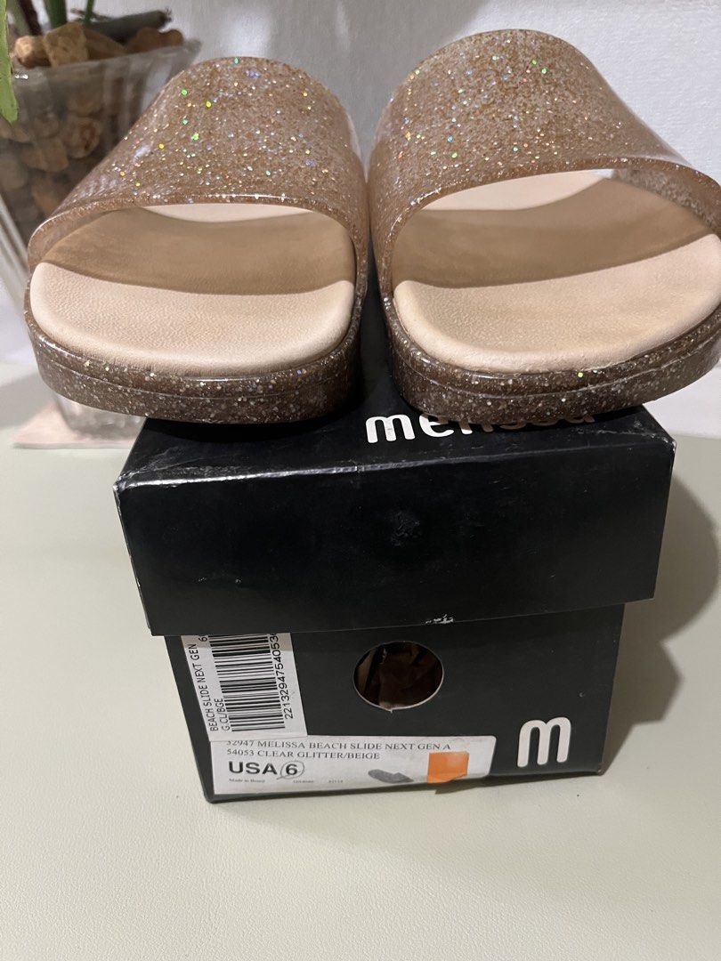 Melissa Beach Slide Next Gen Clear Glitter Beige Slides (Category: Flats & Sandals) located in Quezon City. Submitted by eloveshopping.ph (Listing ID 1468795486, Image 3). Description: - Guaranteed Original Melissa Beach Slide Next Gen - Size: US 6 - Clear Glitter / Pinkish Beige - Super soft, Comfortable slip-on design, sparkly transparent upper strap, and textured soles w/ Original black Melissa box.