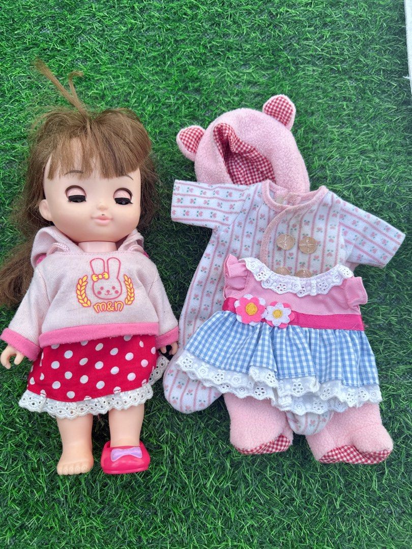 Mell-chan Doll with Extra Outfits and Accessories (Category: Kids Toys) located in Manila. Submitted by ronoarabbit.ph (Listing ID 1468920420, Image 3). Description: ‼️check all photos, selling as is‼️ may ink banda sa nguso❗️hindi ko mahanap yung isang shoe❗️ ✔️Mell-chan doll with brown hair and pink shoes, wearing a pink bunny hoodie and red polka dot skirt. ✔️Bundle includes three extra outfits: a pink fleece bear-eared onesie, a striped rompe