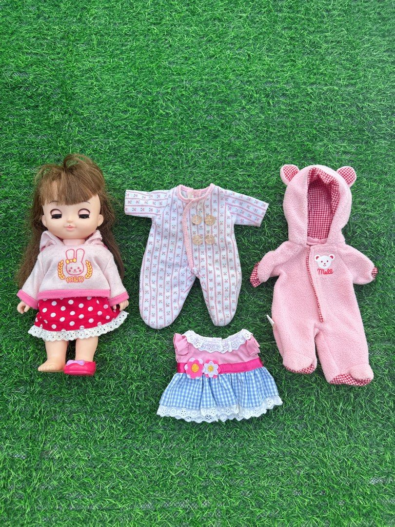 Mell-chan Doll with Extra Outfits and Accessories (Category: Kids Toys) located in Manila. Submitted by ronoarabbit.ph (Listing ID 1468920420, Image 2). Description: ‼️check all photos, selling as is‼️ may ink banda sa nguso❗️hindi ko mahanap yung isang shoe❗️ ✔️Mell-chan doll with brown hair and pink shoes, wearing a pink bunny hoodie and red polka dot skirt. ✔️Bundle includes three extra outfits: a pink fleece bear-eared onesie, a striped rompe