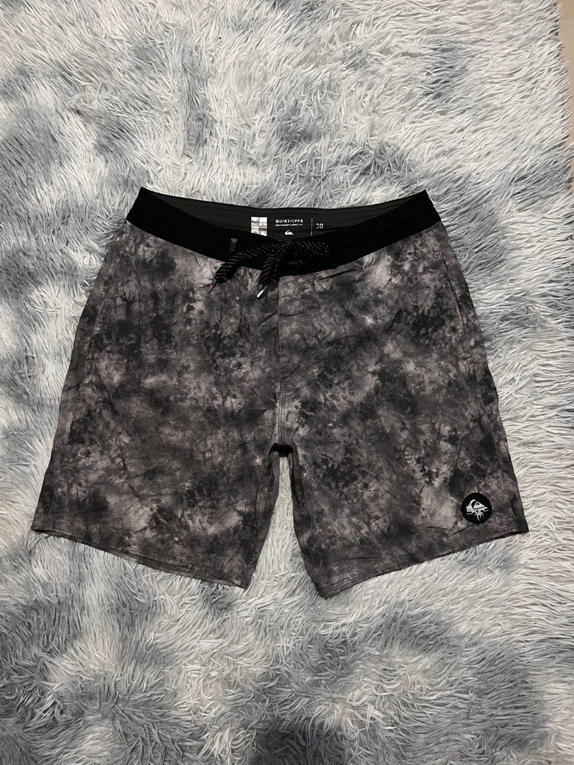 Men's Quiksilver Board Shorts (Category: Swim Trunks & Board Shorts) located in Carmen. Submitted by yawbuangaka (Listing ID 1468745632, Image 2). Description: Quiksilver black and grey tie-dye/cloud-wash boardshorts featuring a black elastic-style waistband, a patterned drawstring, and the Quiksilver mountain-and-wave logo patch on the lower leg. •Waistline - 30 •Length - 17.5 •Excellent.