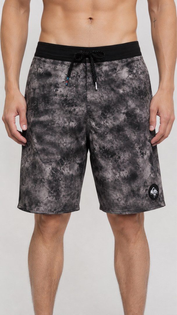 Men's Quiksilver Board Shorts (Category: Swim Trunks & Board Shorts) located in Carmen. Submitted by yawbuangaka (Listing ID 1468745632, Image 1). Description: Quiksilver black and grey tie-dye/cloud-wash boardshorts featuring a black elastic-style waistband, a patterned drawstring, and the Quiksilver mountain-and-wave logo patch on the lower leg. •Waistline - 30 •Length - 17.5 •Excellent.