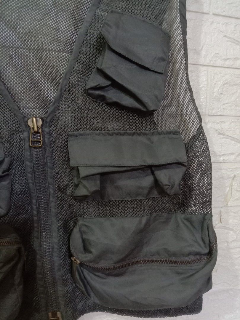 Mens Utility Mesh Vest Multiple Pockets Size Large (Category: Vests) located in Quezon City. Submitted by coolture_thriftph (Listing ID 1468789549, Image 3). Description: - Color & Material: Dark grey breathable mesh fabric - Size: Large (fits chest 41-45 inches) - Style Number: 22500-R - Pockets: Multiple front cargo pockets with secure flap and zipper closures - Closure: Full front zipper with a durable metal pull - Versatile Use: Lightweight l