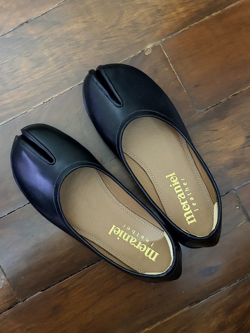 Meraniel Leather Tabi Flats (Category: Flats & Sandals) located in Quezon City. Submitted by fellceas (Listing ID 1468758824, Image 1). Description: - Brand: Meraniel - Color: Black with tan inner sole and gold foil logo - Style: Trendy split-toe tabi design, slip-on - Material: Smooth leather upper - Extras: Heel grips already attached for extra comfort, includes original cardboard shoebox - Pre-ordered, no bow. - Worn only once to fit—too big f