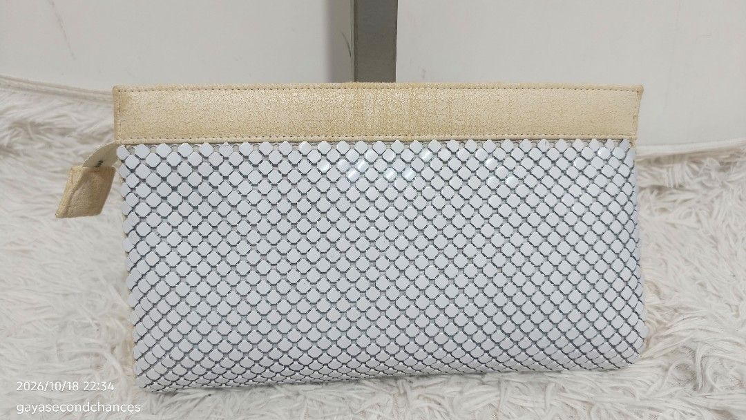 METAL MESH AUSTRALIA STYLE CLUTCH (Category: Clutches) located in Kalibo. Submitted by secondchances.thriftsh8p (Listing ID 1468890603, Image 2). Description: - Material: White mesh metal body with beige leather trim - Hardware & Details: Gold rectangular 'Symbol of Quality' brand badge and side zipper closure with leather pull tab - Interior: Clean beige fabric lining - Condition: Visible cracking and wear on the beige leather sections (priced a
