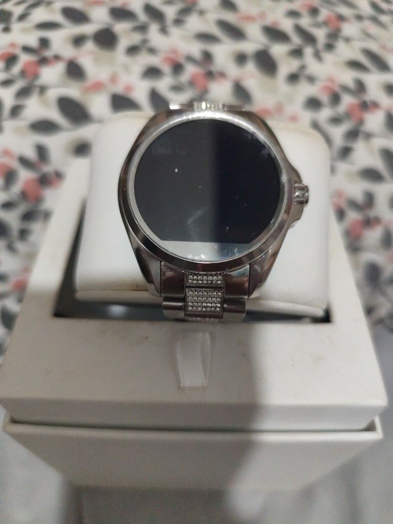Michael Kors Access Silver Smartwatch with Pave Crystals (Category: Women's Watches) located in Manila. Submitted by marriage031073advocate (Listing ID 1468724940, Image 1). Description: - Brand: Michael Kors - Color/Finish: Silver-tone with clean metal finish - Display: Round digital display face - Details: Bracelet strap with embedded pavé crystals on center links and a single crown on the right - Inclusions: Original white presentation box and