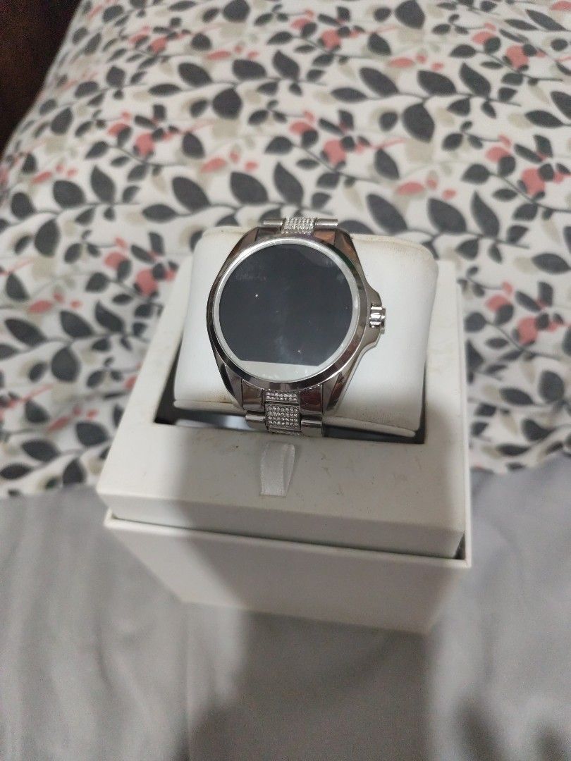 Michael Kors Access Silver Smartwatch with Pave Crystals (Category: Women's Watches) located in Manila. Submitted by marriage031073advocate (Listing ID 1468724940, Image 2). Description: - Brand: Michael Kors - Color/Finish: Silver-tone with clean metal finish - Display: Round digital display face - Details: Bracelet strap with embedded pavé crystals on center links and a single crown on the right - Inclusions: Original white presentation box and