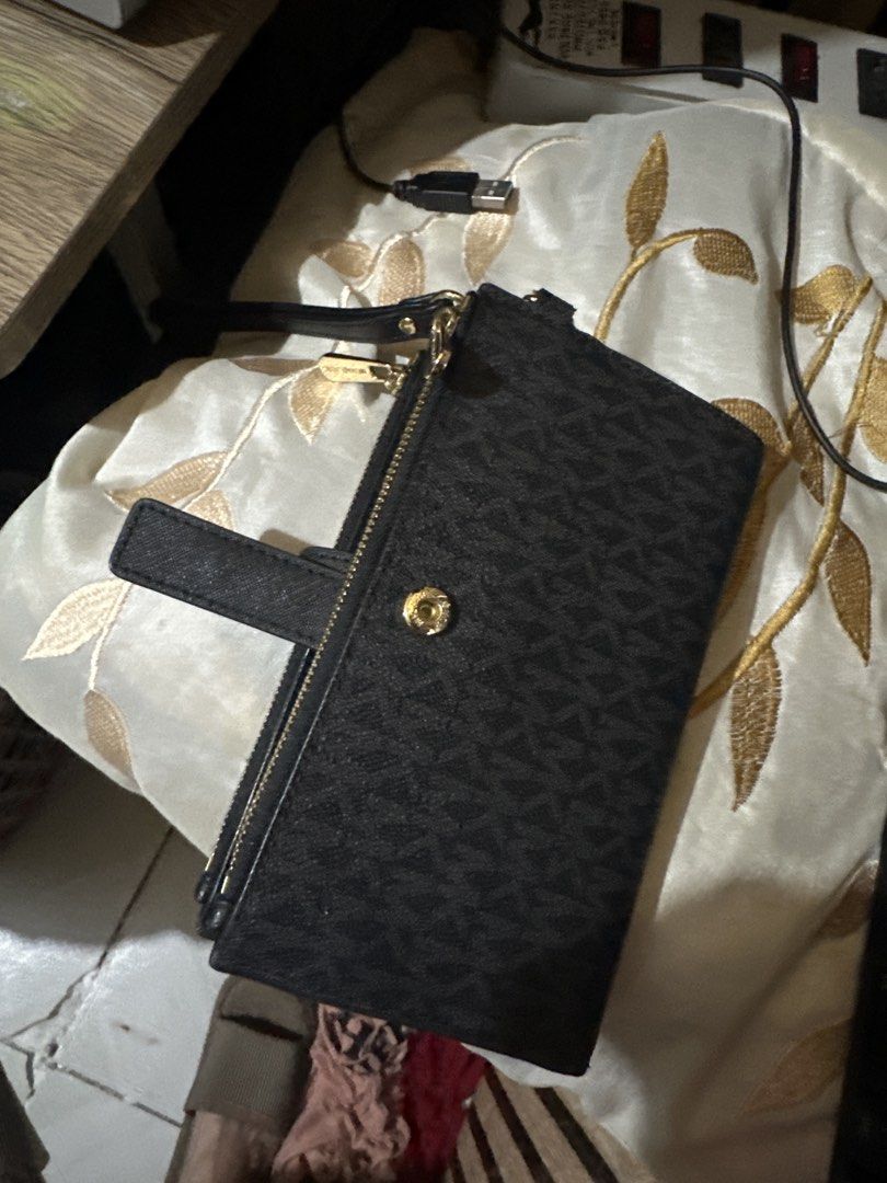 Michael Kors Black Monogram Double Zip Wallet Wristlet (Category: Wallets & Card holders) located in Manila. Submitted by chinitangtisay (Listing ID 1468880849, Image 3). Description: - Brand: Michael Kors - Color: Classic Black with Monogram design - Material: Durable Saffiano leather texture - Hardware: Elegant gold-tone hardware and MK lettering - Compartments: Convenient double zip compartments on top - Closure: Snap tab closure for the main 