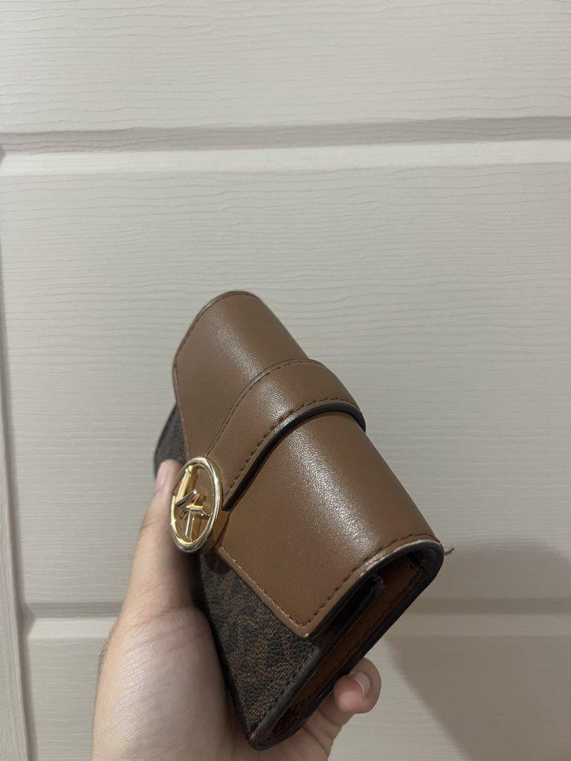 Michael Kors Brown Monogram Bi-fold Wallet (Category: Luxury Bags & Wallets) located in Santa Cruz. Submitted by alliyah. (Listing ID 1468713352, Image 3). Description: Bought this around 3.8k Selling for only 1.8k - Brand: Michael Kors - Style: Bi-fold wallet - Design: Signature monogram print with solid brown leather flap and gold-tone MK circle hardware - Features: Multiple card slots and a secure zippered pocket inside - Size: Compact, fits e