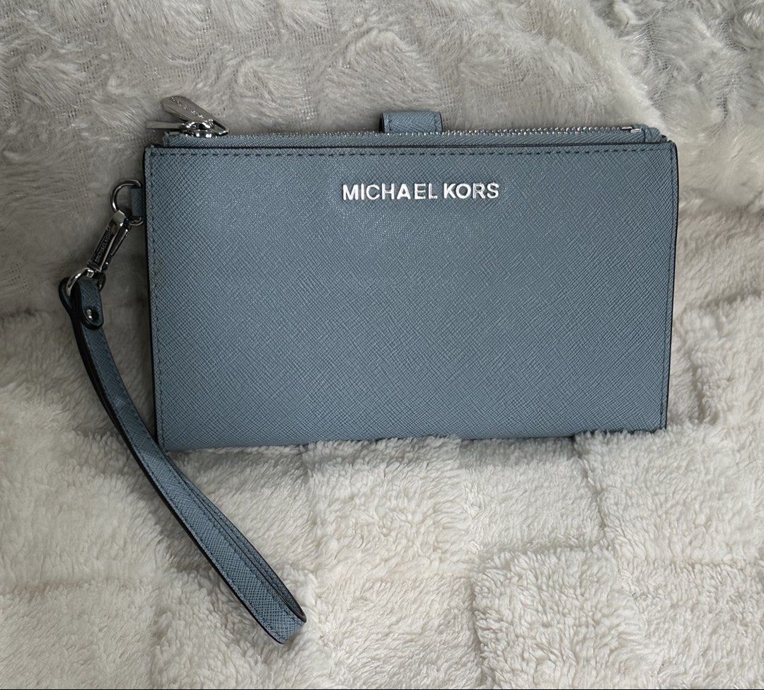 Michael Kors Jet Set Wristlet Wallet Large (Category: Wallets & Card holders) located in Santa Rosa. Submitted by esplanamur03635 (Listing ID 1468775152, Image 2). Description: - Authentic Michael Kors wallet - Material: Premium powder blue -Saffiano leather - Hardware: Silver-tone with clear front logo lettering - dual Zip-around top and 2 snap-button main and inner - Matching detachable wrist -strap - Clean exterior, clean interior multiple com
