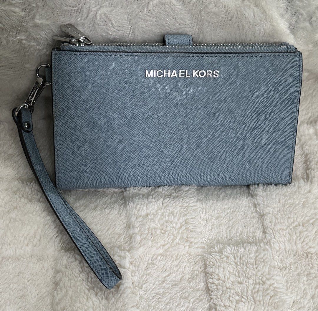 Michael Kors Jet Set Wristlet Wallet Large (Category: Wallets & Card holders) located in Santa Rosa. Submitted by esplanamur03635 (Listing ID 1468775152, Image 1). Description: - Authentic Michael Kors wallet - Material: Premium powder blue -Saffiano leather - Hardware: Silver-tone with clear front logo lettering - dual Zip-around top and 2 snap-button main and inner - Matching detachable wrist -strap - Clean exterior, clean interior multiple com