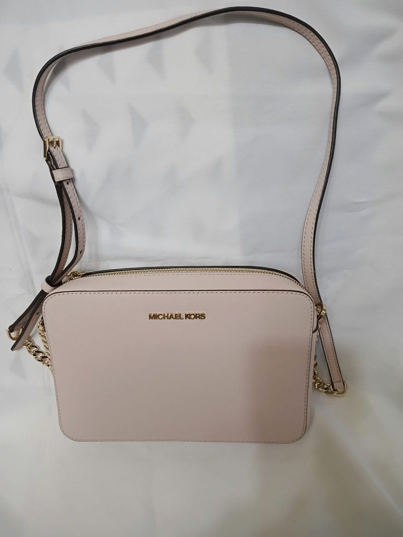 Michael Kors Pink Crossbody Bag (Category: Cross-body Bags) located in Quezon City. Submitted by rosefontanar08 (Listing ID 1468798316, Image 1). Description: - Authentic Michael Kors Crossbody Bag - Color: Light Pink in durable Saffiano leather - Hardware: Gold-toned with secure zip closure - Strap: Adjustable shoulder strap - Interior: Signature logo fabric lining with a convenient slip pocket - Condition: Super clean inside and out - Inclusion