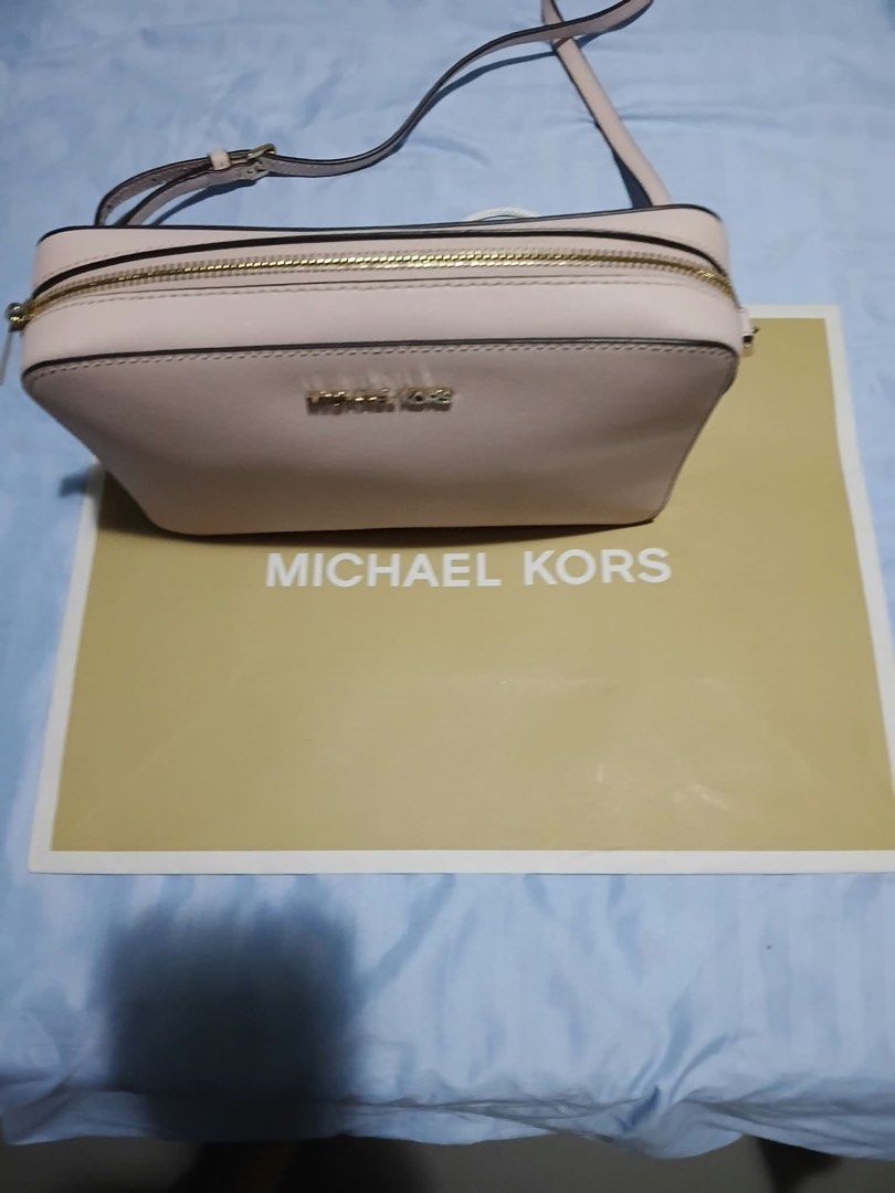 Michael Kors Pink Crossbody Bag (Category: Cross-body Bags) located in Quezon City. Submitted by rosefontanar08 (Listing ID 1468798316, Image 2). Description: - Authentic Michael Kors Crossbody Bag - Color: Light Pink in durable Saffiano leather - Hardware: Gold-toned with secure zip closure - Strap: Adjustable shoulder strap - Interior: Signature logo fabric lining with a convenient slip pocket - Condition: Super clean inside and out - Inclusion